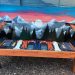 Sunset mountain mural Colorado snowboard bench
