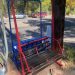 Original two-person chairlift bench in red and blue with a weathered wood slat seat