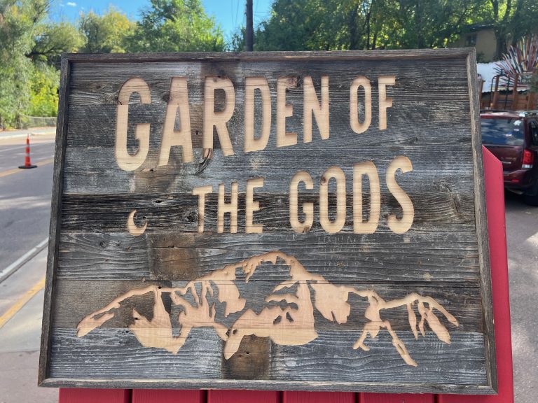 Garden of the Gods carved into reclaimed barnwood with an engraved mountain range silhouette
