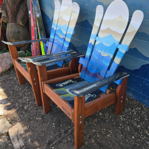 Set of two compact Alpine ski chairs with a blue and white layered mountain mural