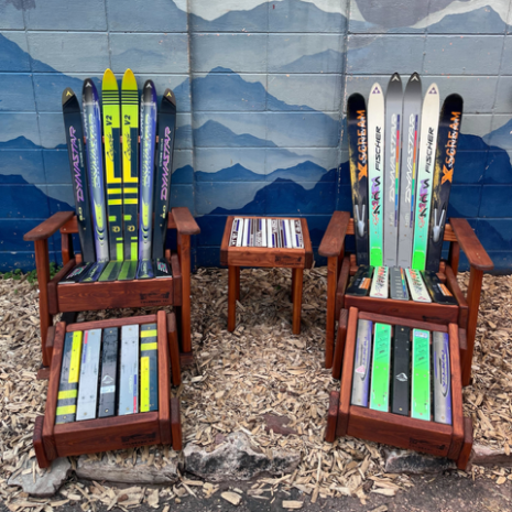 Ski Rocker Patio Set of 5, Front View Ski rocker chair set with ottomans and side table against a hand painted mountain wall