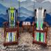Ski rocker chair set with ottomans and side table against a hand painted mountain wall