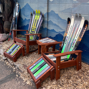 Two ski rocking chairs with matching ski ottomans and a side table built from retired downhill skis