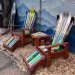 Two ski rocking chairs with matching ski ottomans and a side table built from retired downhill skis