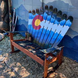 Colorado flag and mountain mural ski bench on rocker runners, built from repurposed skis