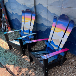 Set of two Alpine Adirondack ski chairs with a hand painted sunset mural over blue peaks