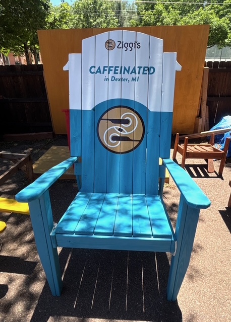 84 inch XXL Adirondack chair painted teal and white with a Ziggi's Coffee logo and cup shaped top