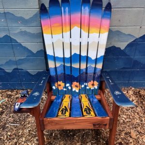 Adirondack ski chair with a hand painted sunset mountain mural and sunflowers across the seat back
