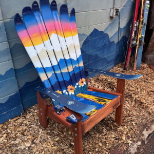 Sunflower Ski Chair, Side View Angled view of a sunset and sunflower ski chair built from retired skis on a redwood stained base